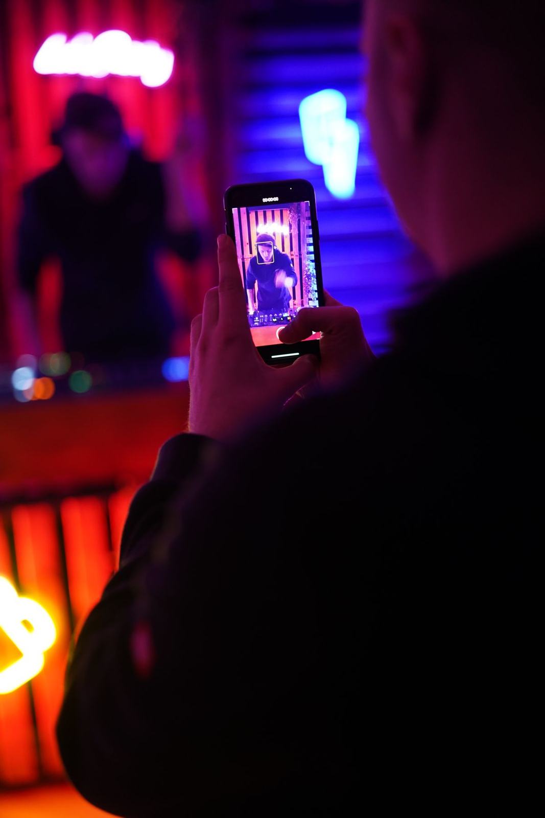 Phone filming the DJ set from the crowd